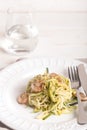 Plate of spaghetti prepared from zucchini and mushroom sauce on wooden table Royalty Free Stock Photo