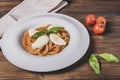 Plate of spaghetti topped with tomato, mozzarella and basil, to recreate the colors of the Italian flag