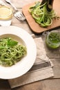 Plate of spaghetti with zucchini and pesto sauce on wooden table Royalty Free Stock Photo