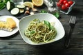 Plate of spaghetti with zucchini and pesto sauce on wooden table Royalty Free Stock Photo