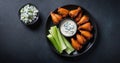 A plate of spicy buffalo wings with celery and blue cheese dip Royalty Free Stock Photo