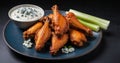 A plate of spicy buffalo wings with celery and blue cheese dip Royalty Free Stock Photo