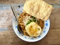 A plate of spicy hot chili oil noodle on wood table