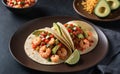 A plate of spicy shrimp tacos with salsa and avocado