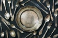 Plate, spoons, forks, knives, silverware pattern on black background. Kitchen texture. Royalty Free Stock Photo