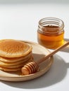 Stack of pancakes and glass jar of honey. Royalty Free Stock Photo