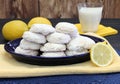 A plate stacked with sugared lemon cookies.