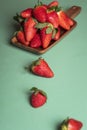 Plate of strawberries on green table. Fresh ripe strawberry fruits Royalty Free Stock Photo