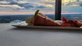 A plate of strawberry short cake with sliced strawberries on a table with a white tablecloth and a gorgeous view of the city Royalty Free Stock Photo