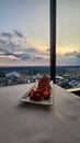 A plate of strawberry short cake with sliced strawberries on a table with a white tablecloth and a gorgeous view of the city Royalty Free Stock Photo