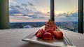 A plate of strawberry short cake with sliced strawberries on a table with a white tablecloth and a gorgeous view of the city Royalty Free Stock Photo