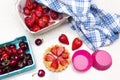 Plate of strawberry tart, cherry in basket.