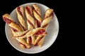 Sugar-free rolls with raspberry jam on a black background