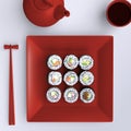 Plate with sushi, chopsticks and tea cup. View from above. Royalty Free Stock Photo