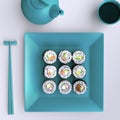 Plate with sushi, chopsticks and tea cup. View from above. Royalty Free Stock Photo