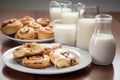 plate of sweet pastries, including cinnamon rolls and shortbread cookies, with glass of milk Royalty Free Stock Photo