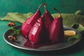 Plate with sweet poached pears in red wine on color background Royalty Free Stock Photo