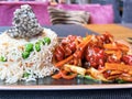Plate with sweet and sour chicken and rice with vegetables Royalty Free Stock Photo