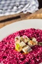 Plate of tasty beetroot risotto with cheese and aperitif Royalty Free Stock Photo