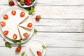 Plate with tasty cheesecake with strawberries and mint on a wooden background.