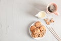 Plate with tasty chocolate chip cookies and cup of coffee on gray background, top view Royalty Free Stock Photo