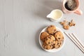 Plate with tasty chocolate chip cookies and cup of coffee on gray background, top view Royalty Free Stock Photo