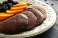 Plate with tasty chocolate pancakes, fruit and berries, closeup