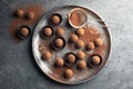 Plate with tasty chocolate truffles on grey background Royalty Free Stock Photo