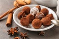 Plate with tasty chocolate truffles on grey table Royalty Free Stock Photo