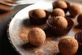 Plate with tasty chocolate truffles on grey table Royalty Free Stock Photo