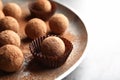 Plate with tasty chocolate truffles on table, space for text Royalty Free Stock Photo