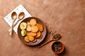 Plate with tasty cooked sweet potatoes, rosemary, sauce and spices, herbs on textured background Royalty Free Stock Photo