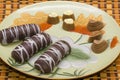 Plate with tasty cookies and chocolates on a good background