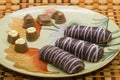 Plate with tasty cookies and chocolates on a good background