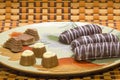 Plate with tasty cookies and chocolates on a good background