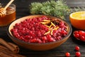 Plate of tasty cranberry sauce with citrus zest and anise on table Royalty Free Stock Photo