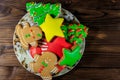 Plate with tasty festive Christmas gingerbread cookies on wooden table. Top view Royalty Free Stock Photo