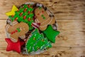 Plate with tasty festive Christmas gingerbread cookies on wooden table. Top view Royalty Free Stock Photo