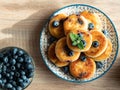 Plate with tasty fluffy pancakes with blueberries, honey Royalty Free Stock Photo