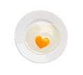 Plate with tasty fried egg with yolk in shape of heart on white background, top view Royalty Free Stock Photo