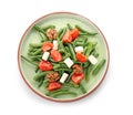 Plate with tasty green beans, nuts, tomatoes