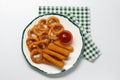 Plate with tasty ketchup, cheese sticks and onion rings on white table, top view Royalty Free Stock Photo