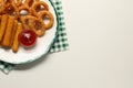 Plate with tasty ketchup, cheese sticks and onion rings on white table, top view. Space for text Royalty Free Stock Photo