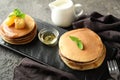 Plate with tasty pancakes and honey on table Royalty Free Stock Photo