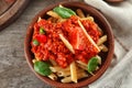 Plate with tasty penne pasta and bolognese sauce on wooden table, top view Royalty Free Stock Photo