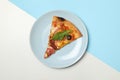 Plate with tasty pizza on two tone background, top view Royalty Free Stock Photo