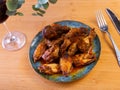 Plate of tasty snack - roasted chicken wings closeup