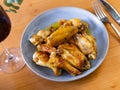 Plate of tasty snack - roasted chicken wings closeup