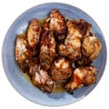 Plate of tasty snack - roasted chicken wings closeup