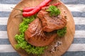 Plate with tasty steaks, herbs, chili and spices on napkin Royalty Free Stock Photo